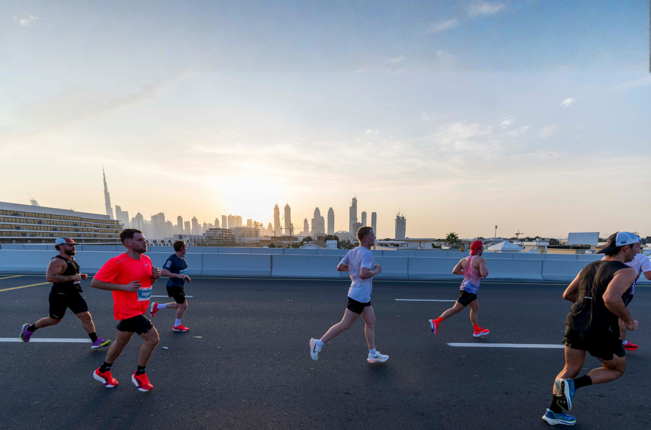 Runners on the Burj2Burj Half Marathon route with the Dubai skyline